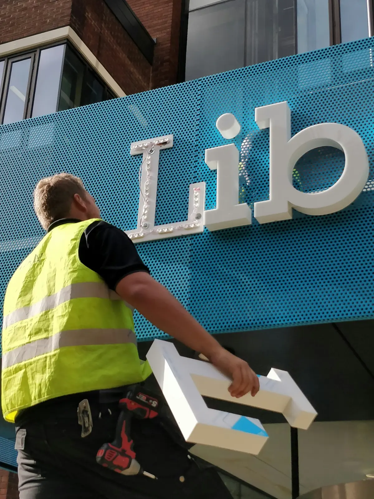 Commercial lettering being installed